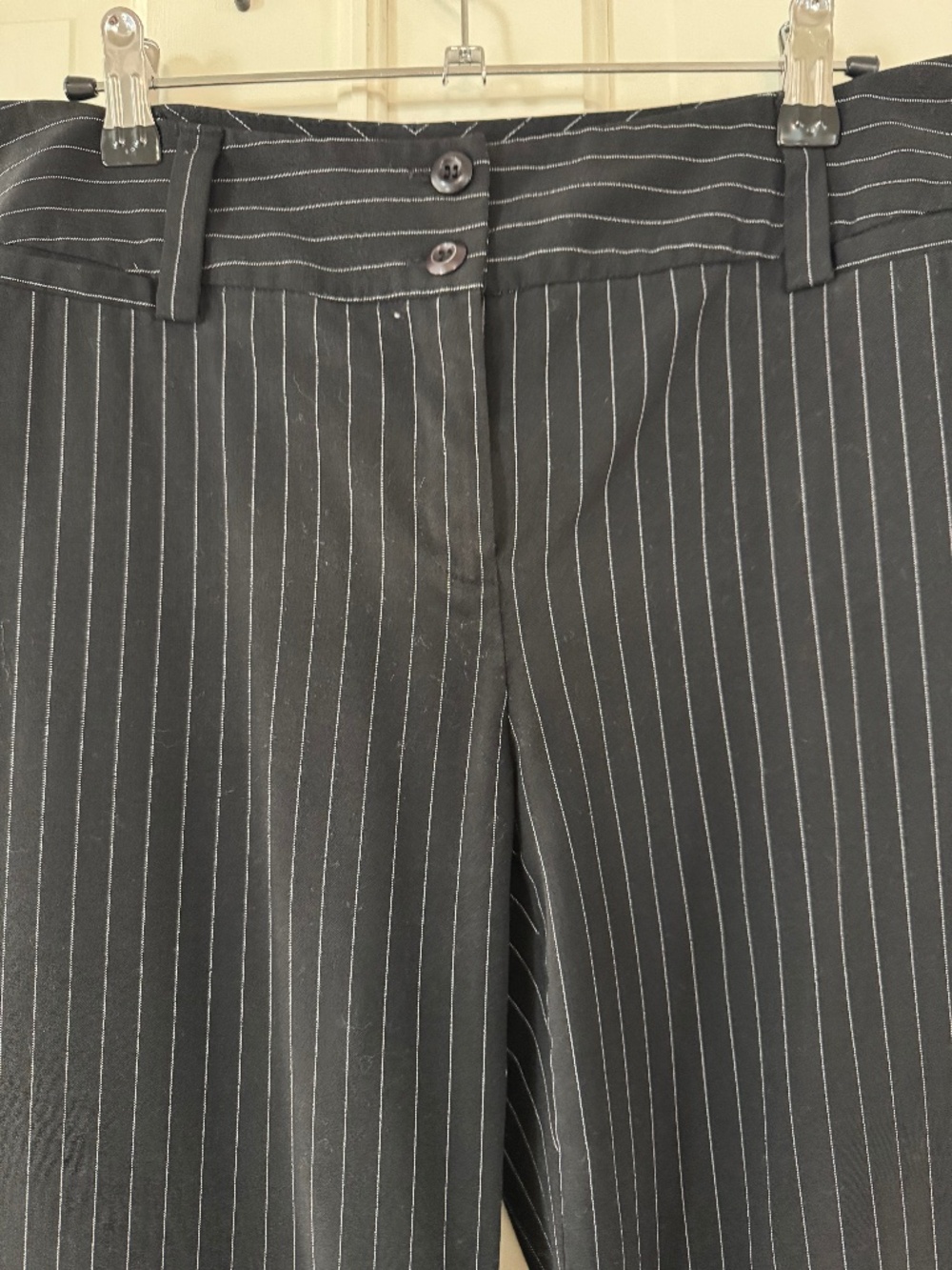 Black pants with white pinstripes.